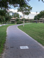 Bike lane between trees in Jardin del Turia in Valencia Spain, cycleway signposted a ground bikeway for cyclists only