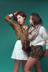 Two beautiful girls on a green background