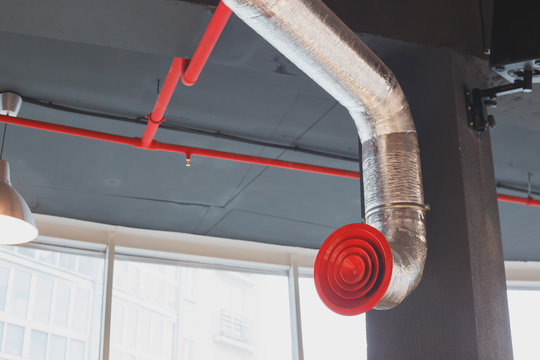 Rounded duct work red metal grill. - Powered by Adobe