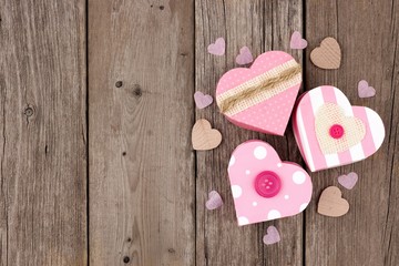 Valentines Day heart shaped gift boxes with soft pink and burlap trim in a cluster over wood