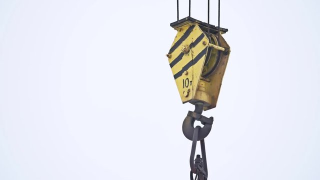 crane hook lifts cargo, loading cargo building