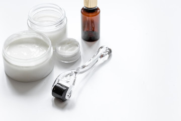 concept beautician desktop with mezoroller - mesotherapy on white background