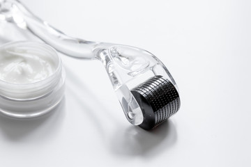 concept beautician desktop with mezoroller - mesotherapy on white background