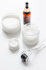 concept cosmetologist desktop with mezoroller - mesotherapy on white background