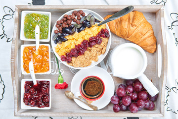 Daily breakfast on a wooden tray. Breakfast in bed