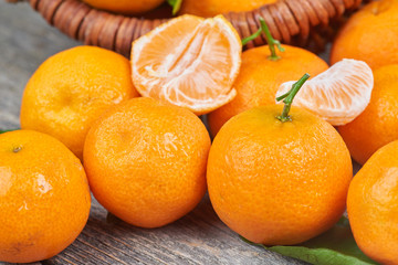 Fresh tangerines with leaves on a wooden table