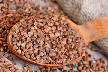 Spoon with buckwheat on table