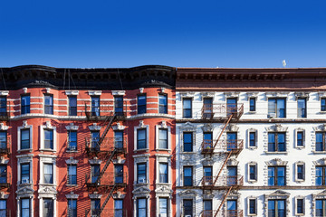 Block of old buildings in New York City with blue sky background