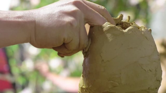 Close up clay doll making