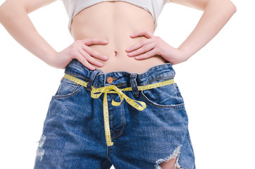  Diet.Young Girl in blue jeans large size on a white background