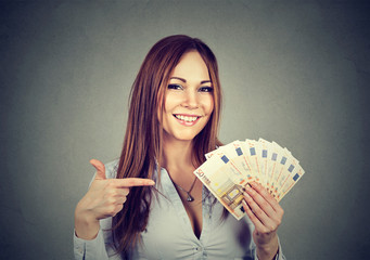 Successful young business woman holding money euro bills in hand - obrazy, fototapety, plakaty