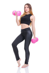 .Diet. Young beautiful girl with pink dumbbells in his hands. Girl performs sporting exercise.