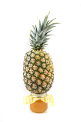 Whole fresh pineapple and jar of pineapple jam isolated on a white background