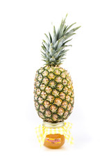 Whole fresh pineapple and jar of pineapple jam isolated on a white background