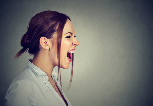 angry woman screaming with wide open mouth