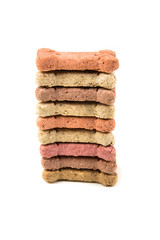 Stack of multicolored dog biscuits isolated on a white background