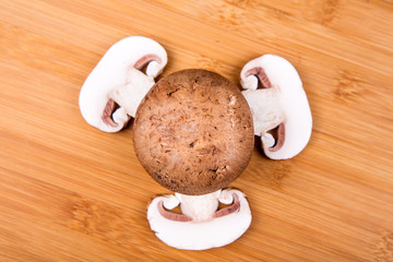 Fresh white mushrooms isolated on a wood background