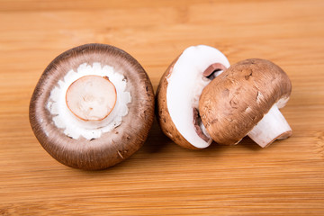 Fresh white mushrooms isolated on a wood background
