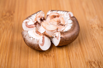 Fresh white mushrooms isolated on a wood background