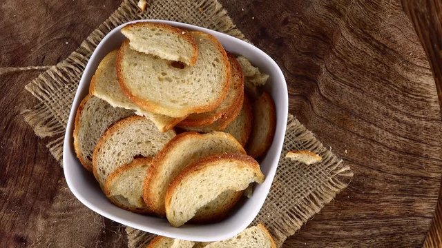 Not loopable Bread Chips (4K footage) on a rotating wooden plate