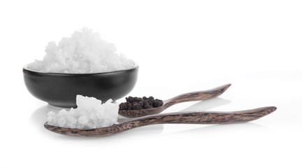 Pepper and salt on a wooden spoon isolated on white background.