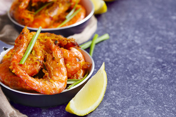 Shrimps roasted on frying pan with lemon and garlic