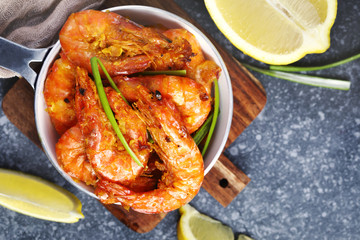 Shrimps roasted on frying pan with lemon and garlic