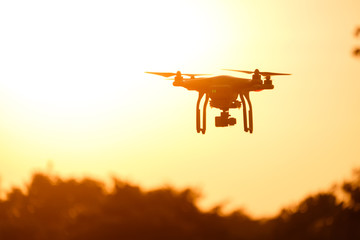Drone silhouette flying in the sunset light beautiful