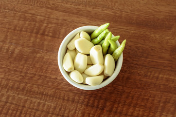 Fresh garlic and chilli in white bowl. Spices.