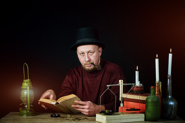 Stylized portrait of a man in a top hat with a pipe , old books and candles