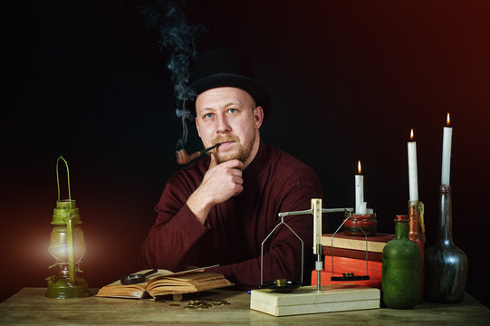 Stylized portrait of a man in a top hat with a pipe , old books and candles