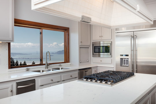 Kitchen Island With White Marble Countertop And Gas Stove.