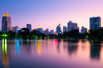 Lumpini park and city skyline in Bangkok, Thailand.