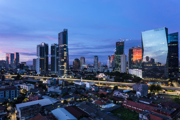 Naklejka na ściany i meble Jakarta sunrise over modern skyline in Indonesia capital city