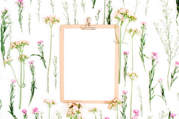 Clipboard mockup and wildflowers pattern. Flat lay, top view