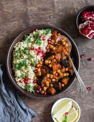 Vegetarian dinner - bulgur and eggplant chickpea stew on a wooden table, top view