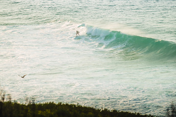 A lone surfer on the waves next to the lagoon of Obidos. Portugal