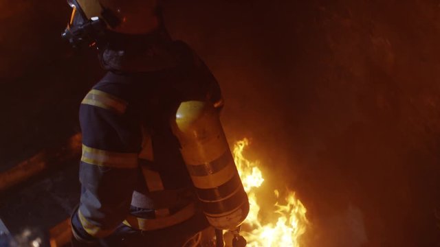 Brave Fireman Goes Up Burning Stairs. Building is on Fire. Flame and Smoke Everywhere. Shot on RED EPIC (uhd).