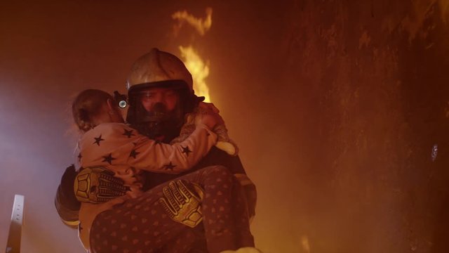 Brave Fireman Descends Stairs of a Burning Bilding with a Saved Girl in His Arms.   Shot on RED EPIC (uhd).