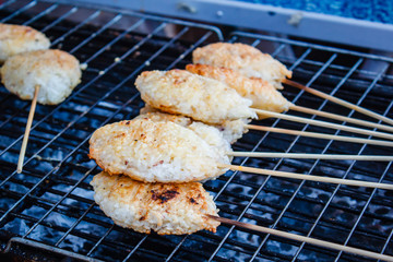 Kao Ji, grilled sticky rice dipped in egg.