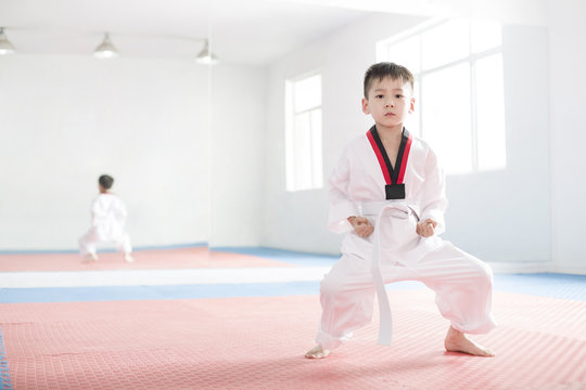 Cute boy practicing Tae Kwon Do
