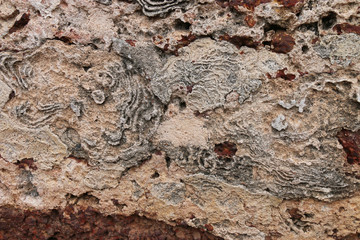 Weathered stone wall background of the ancient city.