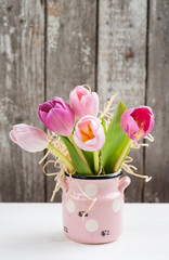 Red pink tulips on rustic background