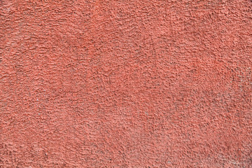 Red, plastered walls with cracks and irregularities