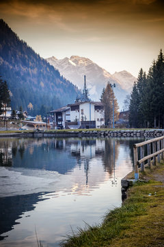 Sunset in the village in the Alpine mountains. Madonna di Campig