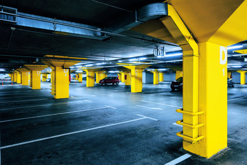 Underground garage parking lot with few cars and empty spaces