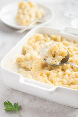 baked macaroni and cheese in white casserole dish