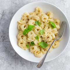 cheese tortellini served with parmesan and basil