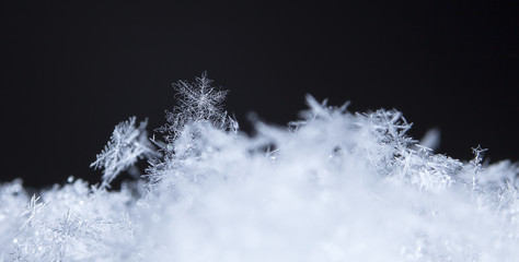 natural snowflakes, photo real snowflakes during a snowfall, under natural conditions at low temperature