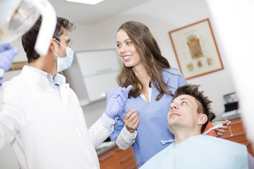 Fototapeta premium Young man having dental chekup at dentist office